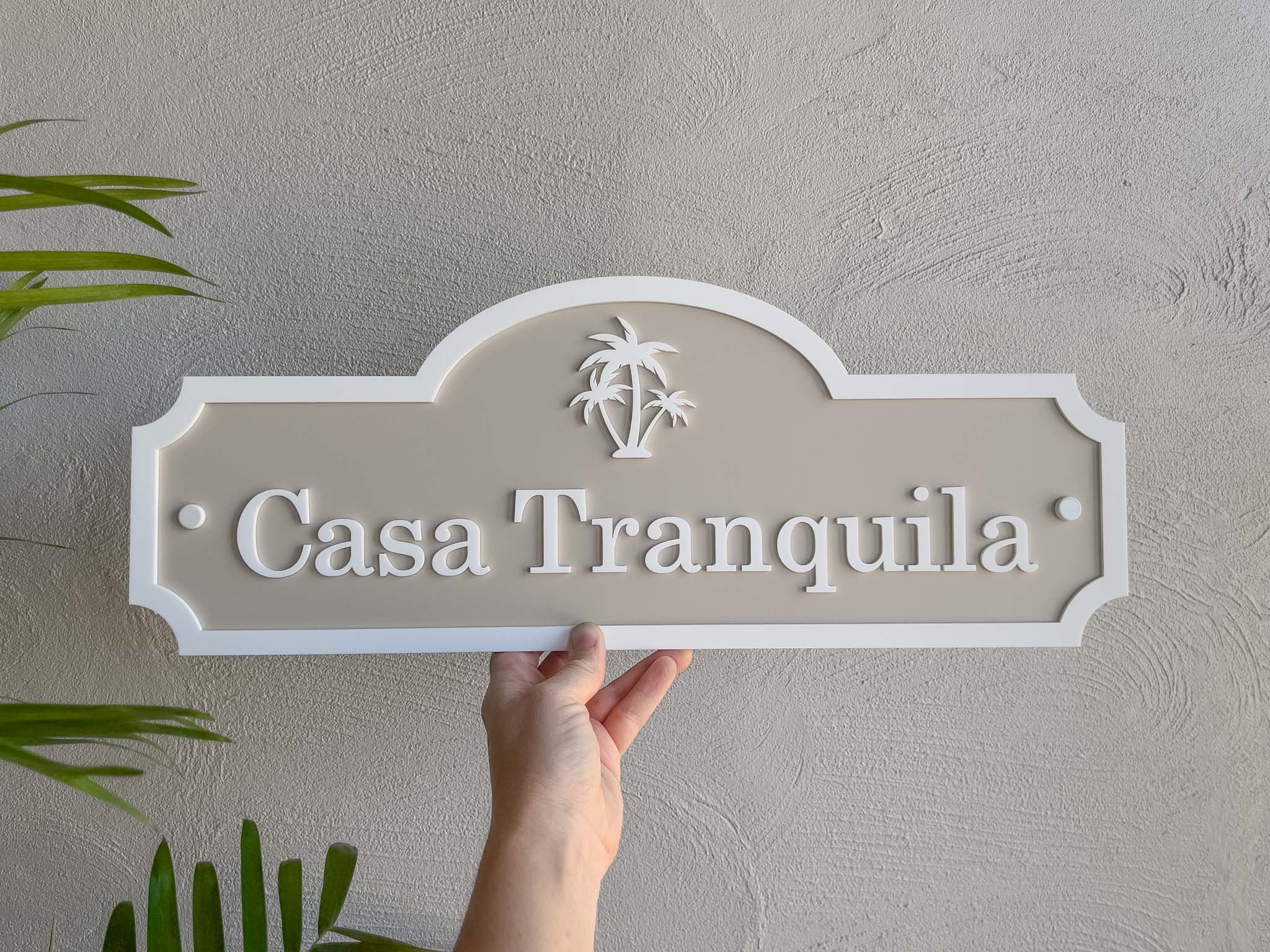 Classic beige and white scalloped edge palm tree sign made in 3D laser cut acrylic that says 'Casa Tranquila'.