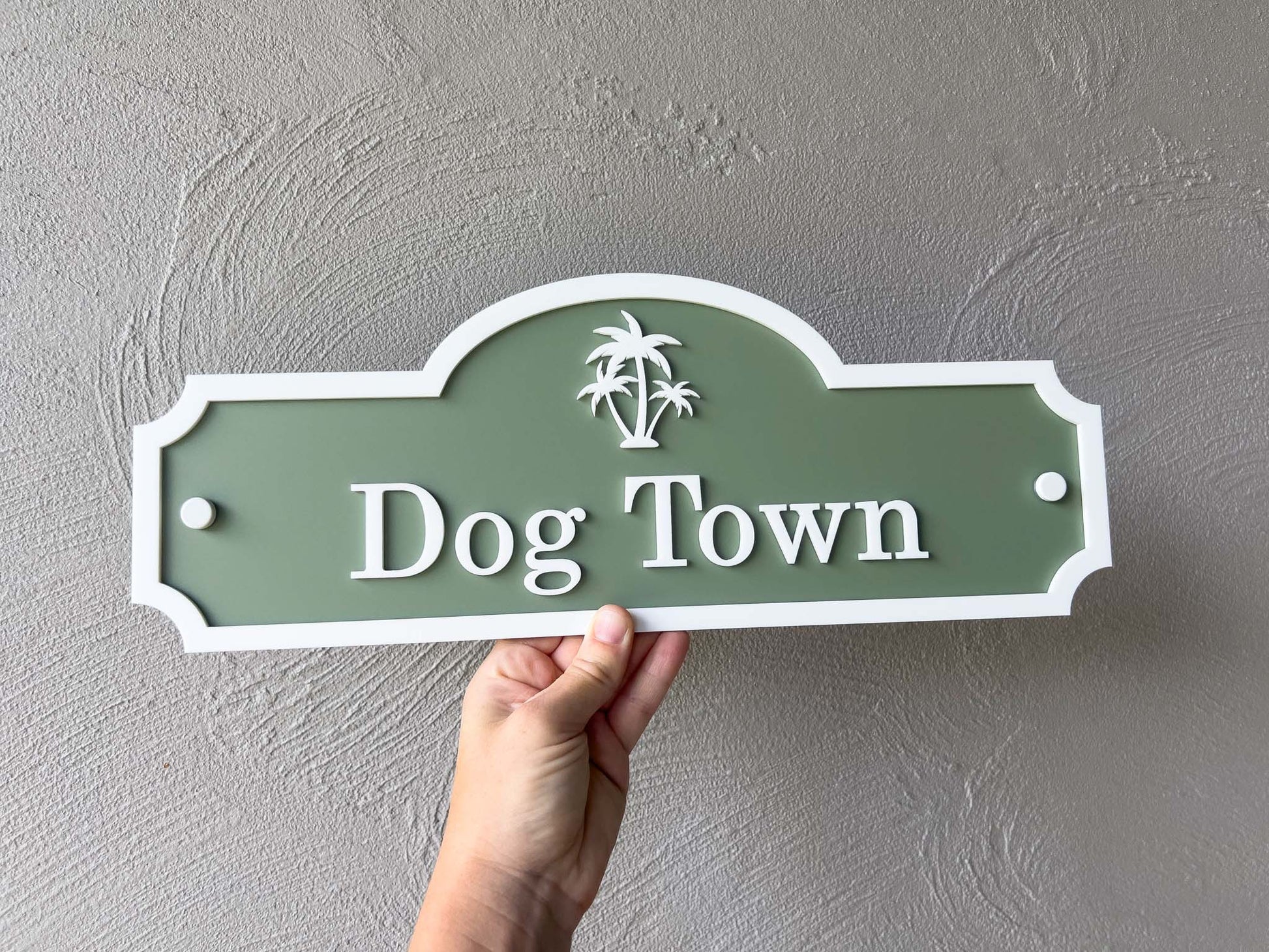 A heritage green and white custom made sign that says 'Dog Town' with a palm tree.