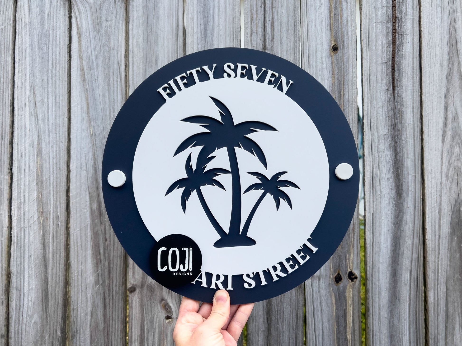 Coastal deep blue and white tropical palm tree address sign laser cut with the number 'Fifty Seven'.
