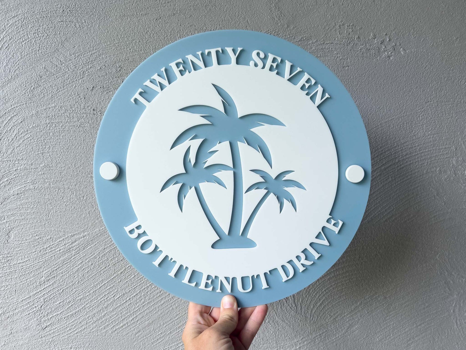 Tropical blue and white coastal palm tree address sign with number 'Twenty Seven'.