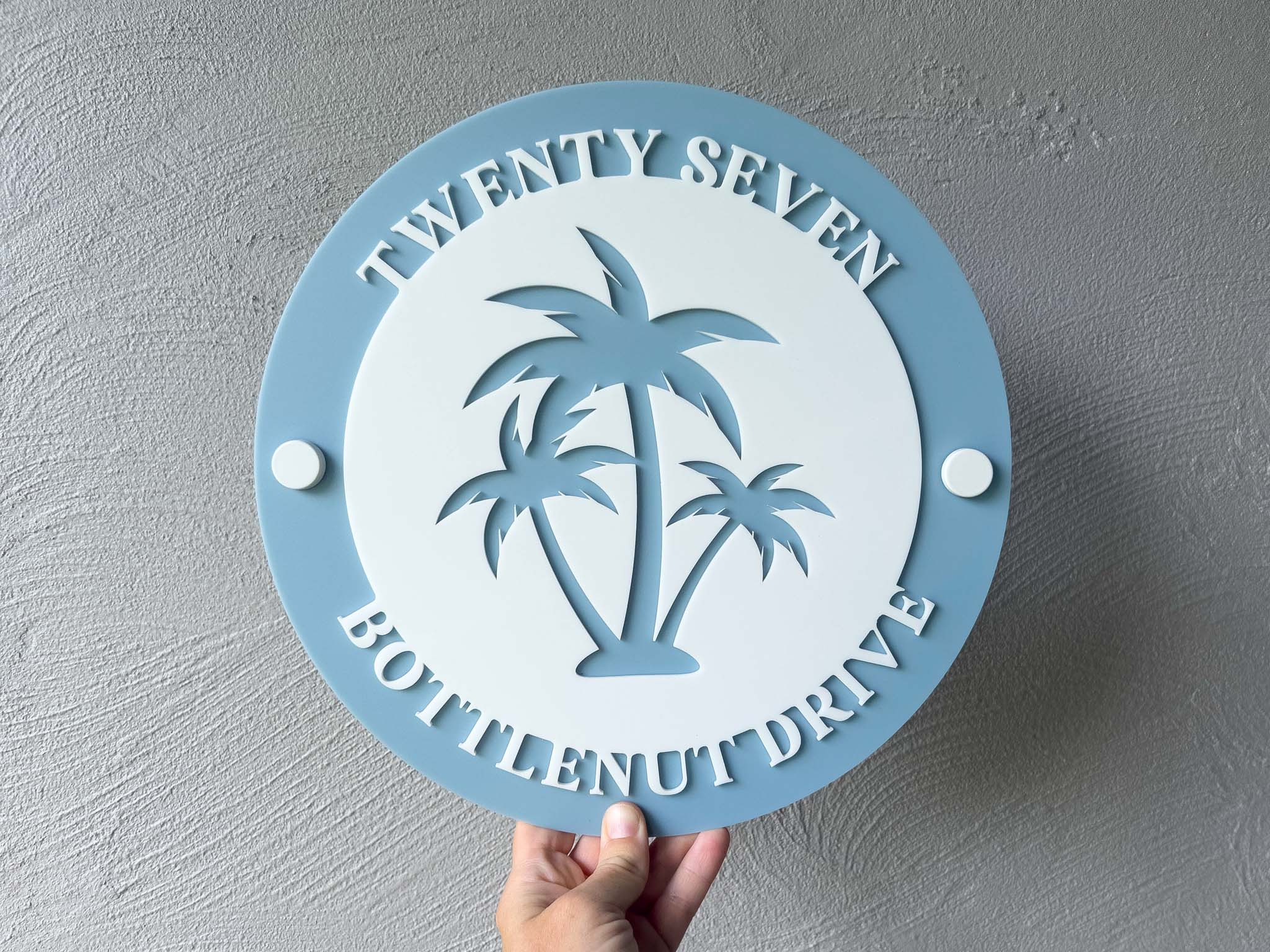 Tropical blue and white coastal palm tree address sign with number 'Twenty Seven'.