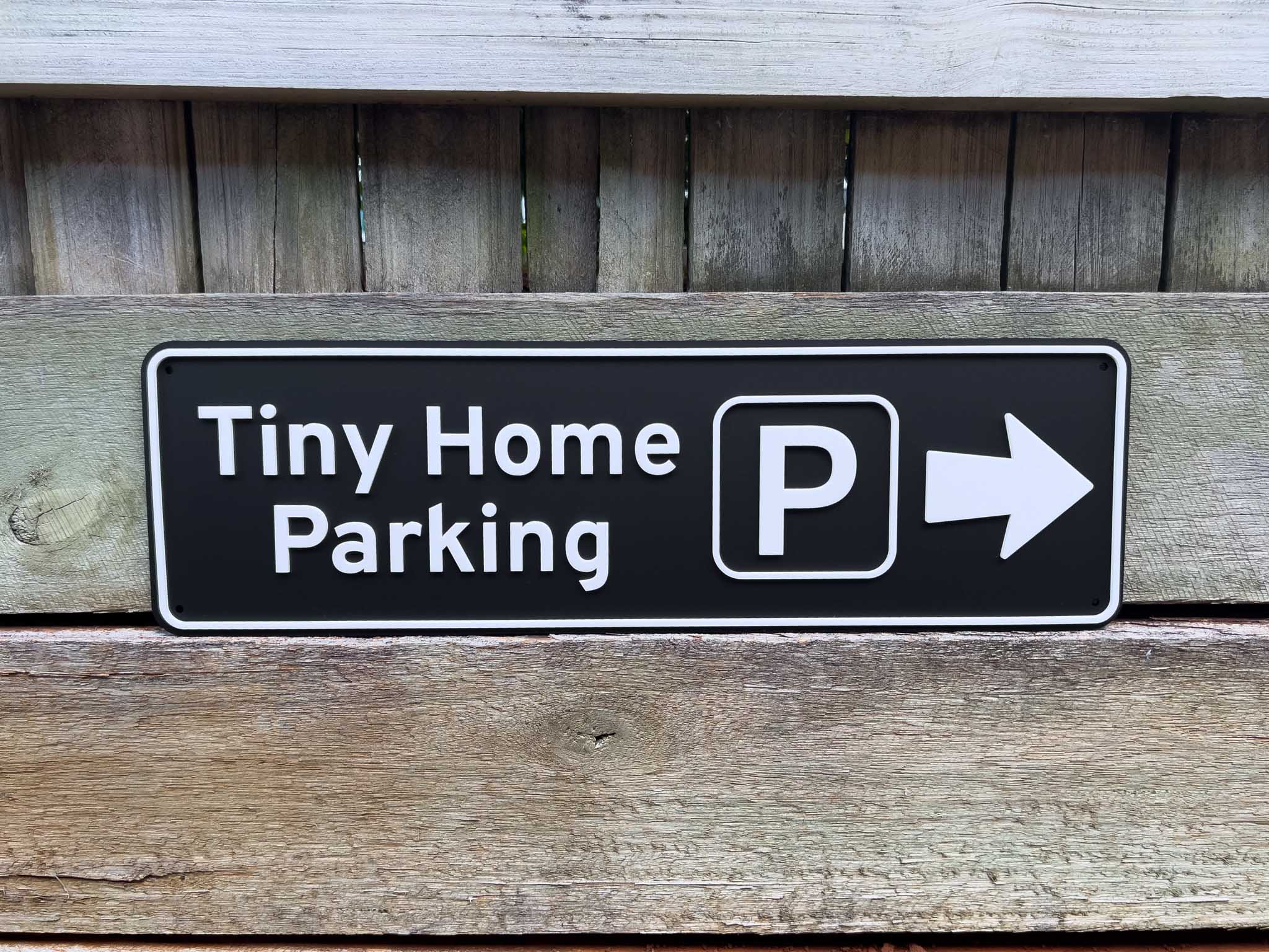 Sign indicating 'Tiny Home Parking' with a right arrow on a wooden background | Coji Designs