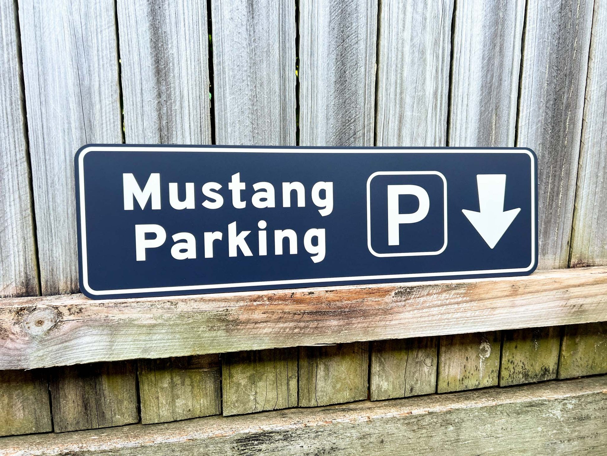 Novelty parking Sign with 'Mustang Parking' with a white arrow on a wooden background