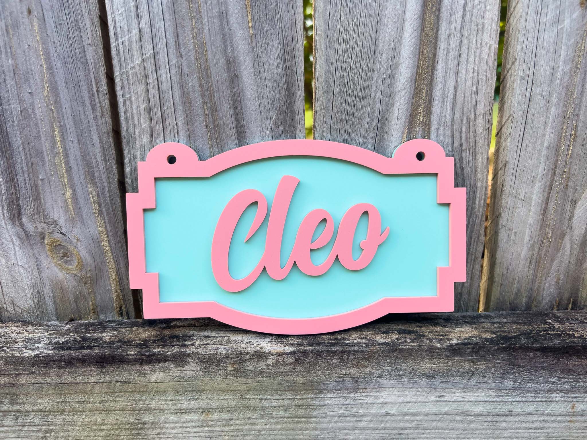Decorative sign with 'Cleo' on a wooden background | Coji Designs