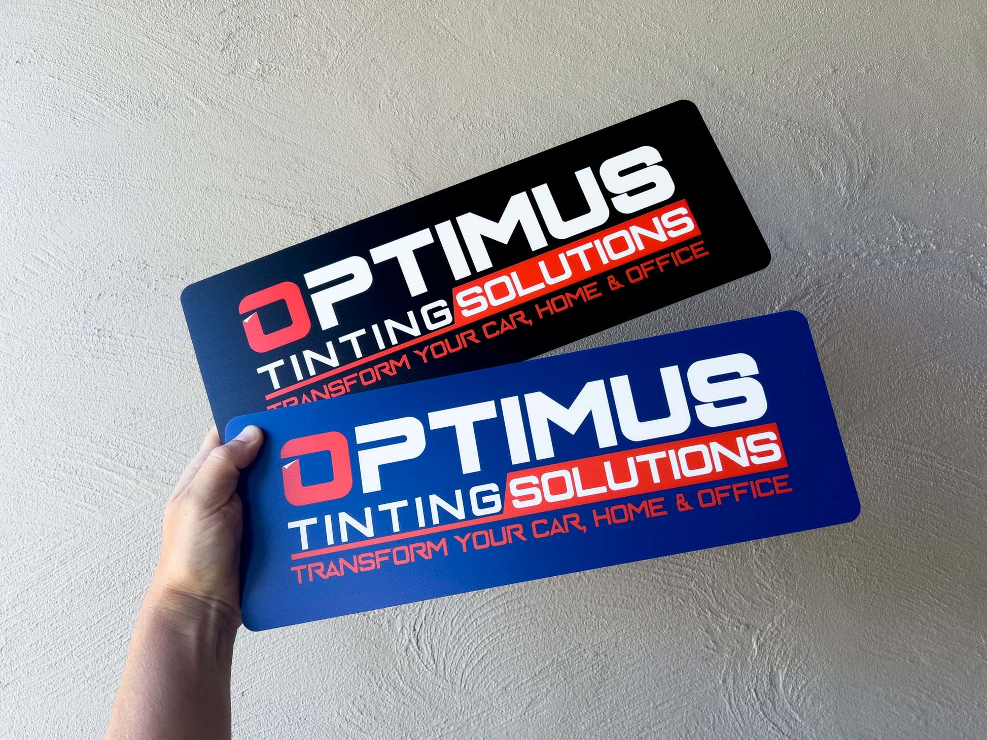 Two custom UV printed logo plates in black and blue with the brand name 'Optimus'.