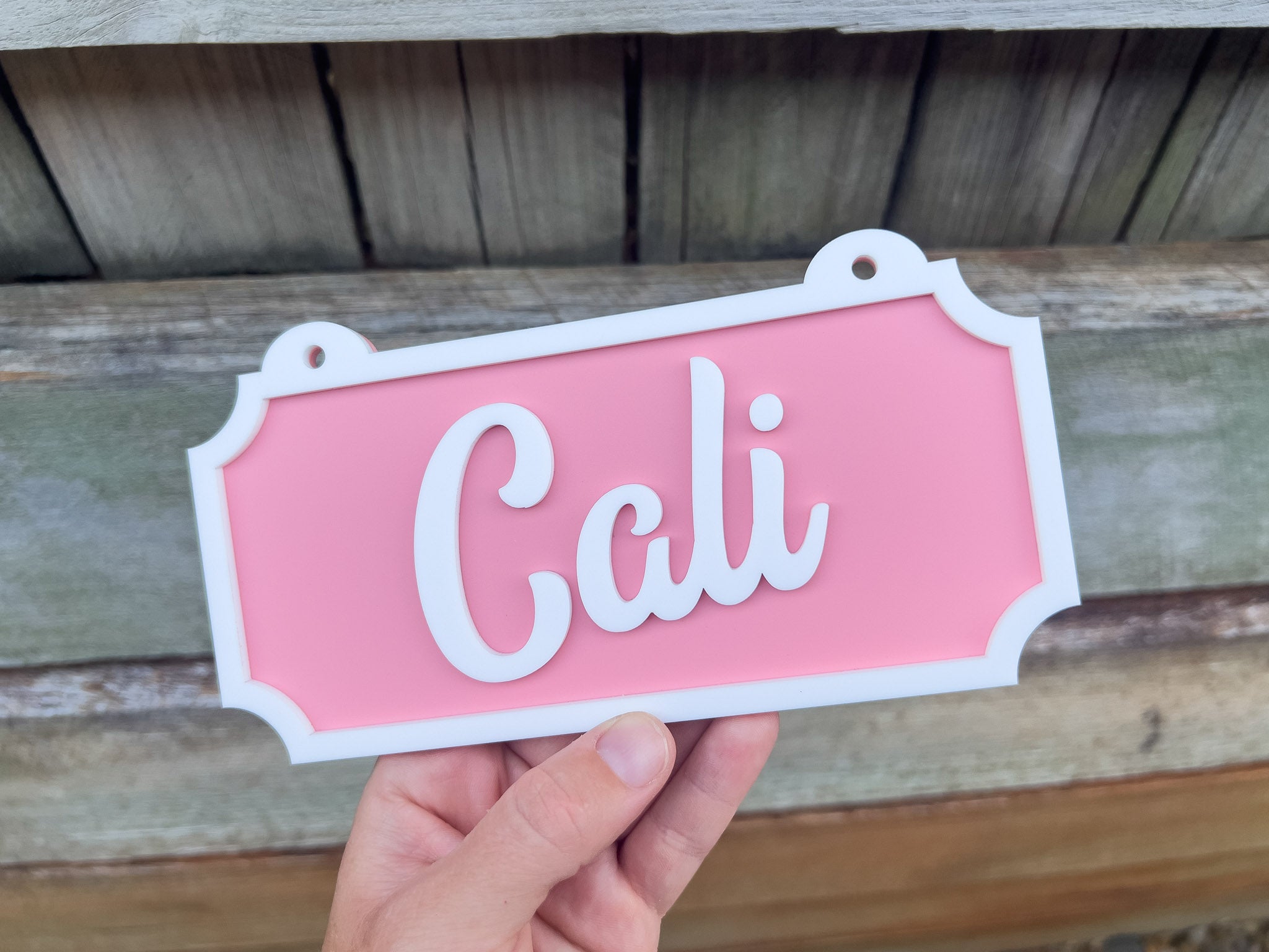 Pink sign with 'Cali' on a wooden background | Coji Designs