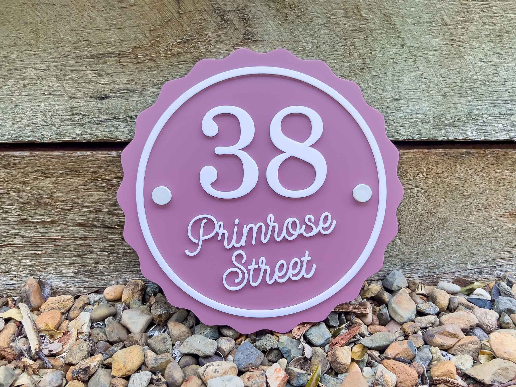 Dusty pink and white 3D acrylic address sign with white mounts that says '38 Primrose Street'.