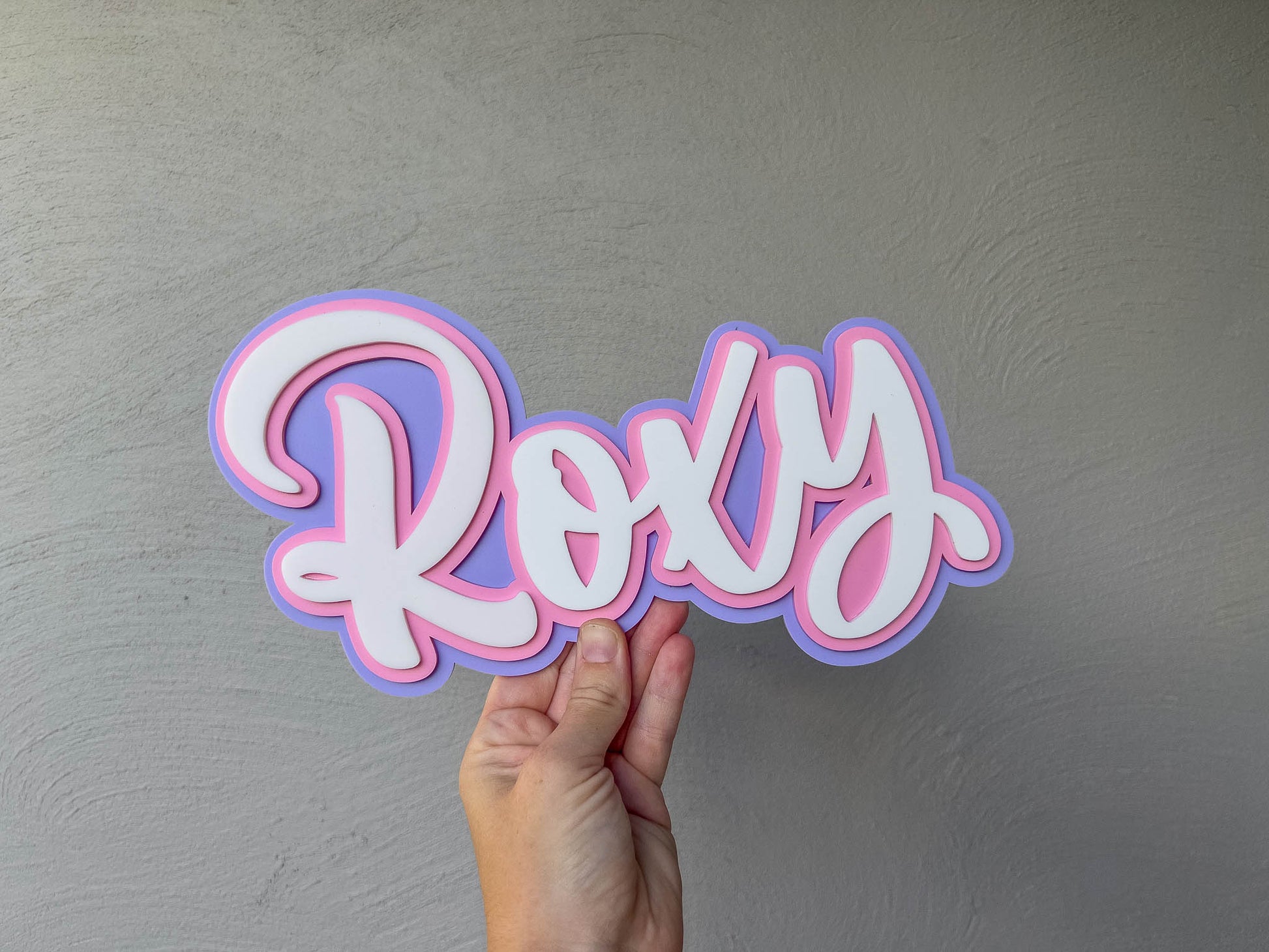 Mini 3D acrylic name plaque 'Roxy' in purple, pink and white.