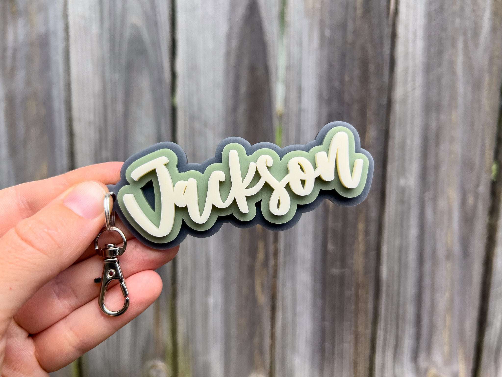 A retro inspired hand script font keychain with the name 'Jackson'.
