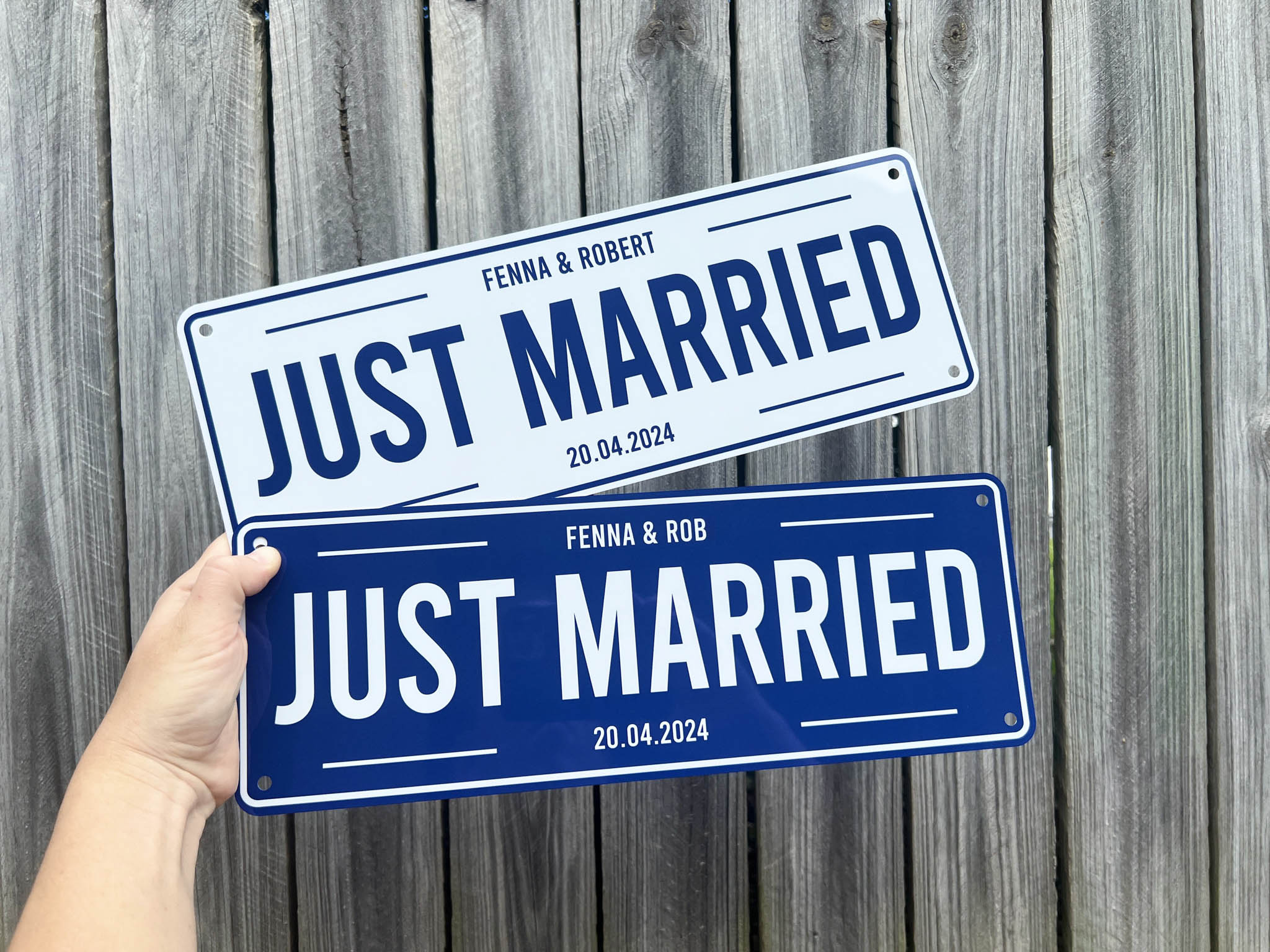 Two 'Just Married' Wedding signs held against a wooden background | Coji Designs
