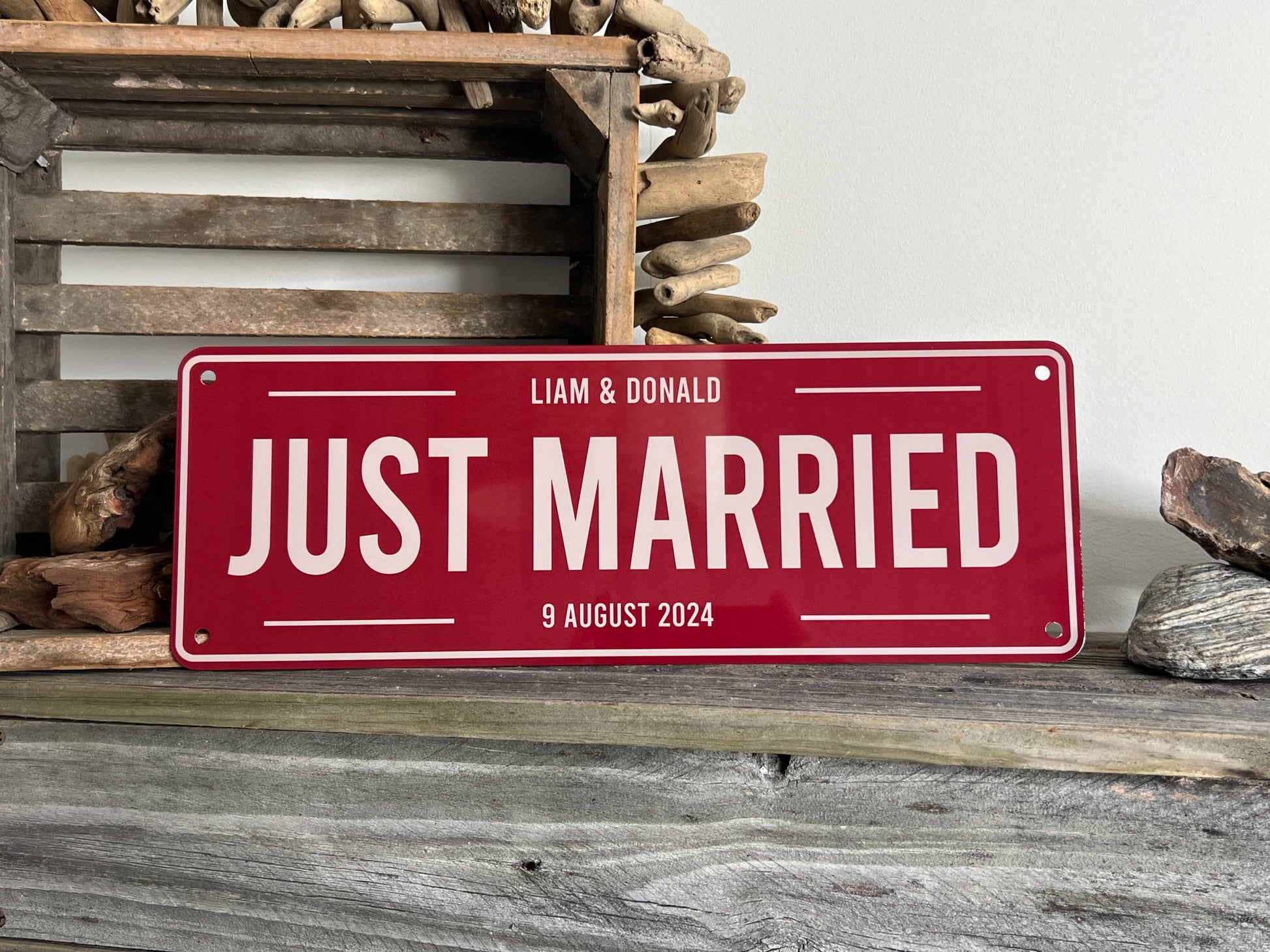 Red 'Just Married' Wedding Plate sign with personalized names and date on a wooden background | Coji Designs