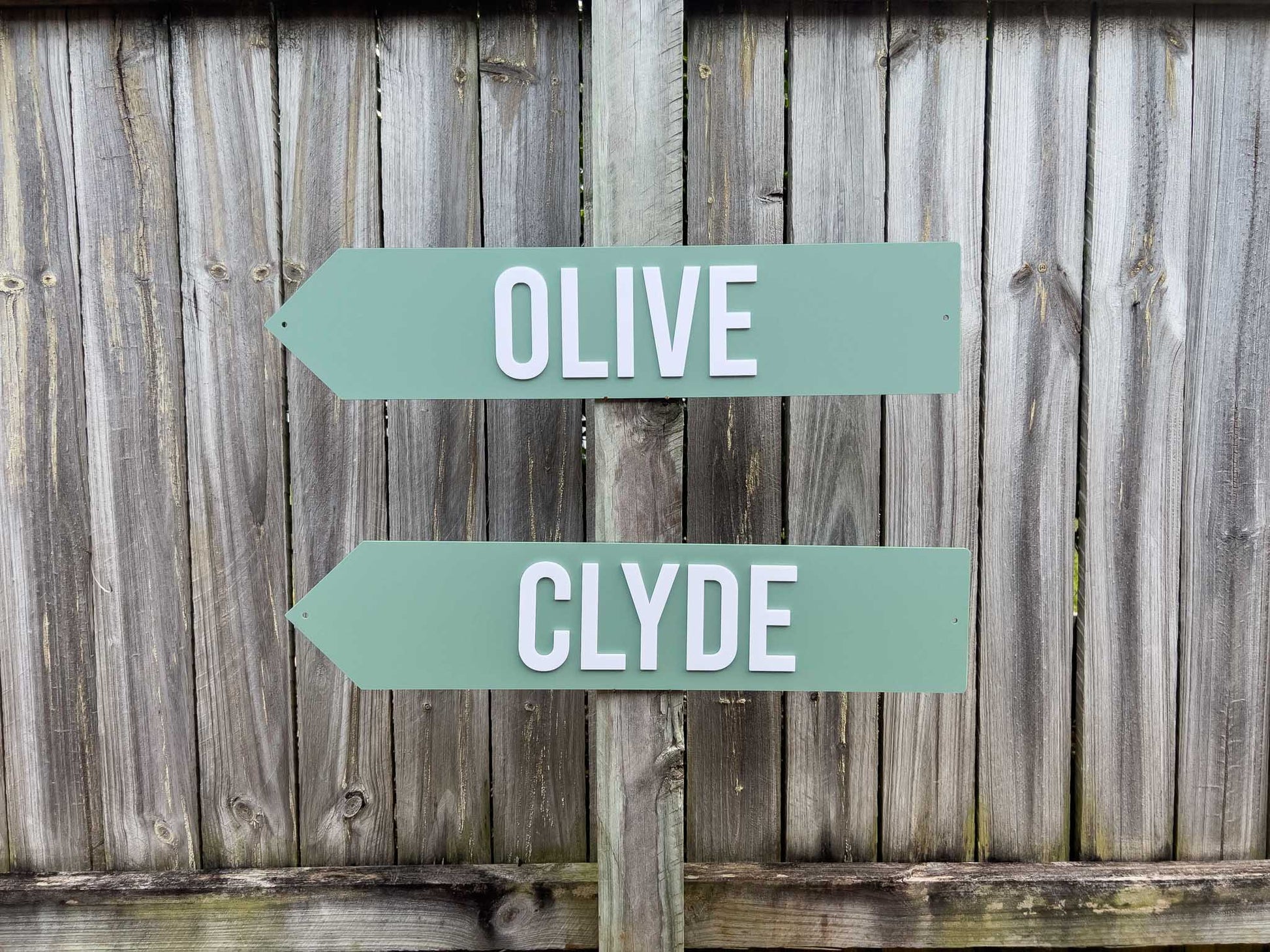 Two green signs with 'OLIVE' and 'CLYDE' text on a wooden background | Coji Designs