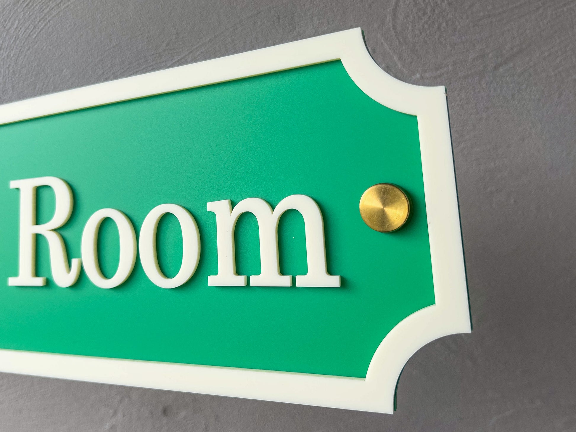 Green and beige side view of a 3D acrylic sign